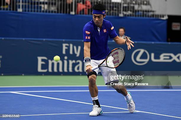 Kei Nishikori of Japan returns a shot to Ryan Harrison of the United States during their singles match on Day 3 of the Memphis Openat the Racquet...