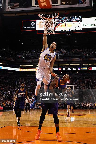 Shaun Livingston of the Golden State Warriors attempts a slam dunk over Orlando Johnson of the Phoenix Suns during the second half of the NBA game at...