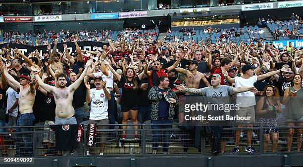 Wanderers fans in the crowd let off flares as police officers look on during the round 18 A-League match between the Melbourne Victory and Western...