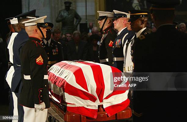 Military honor guard stands next to the casket of former U.S. President Ronald Reagan during a state funeral in the Capitol Rotunda on Capitol Hill...