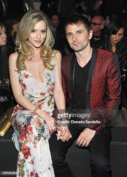 Model Elle Evans and recording artist Matt Bellamy of Muse, in Saint Laurent by Hedi Slimane, attend Saint Laurent at the Palladium on February 10,...