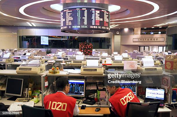 Traders work on the trading floor of the Hong Kong Stock Exchange, operated by Hong Kong Exchanges and Clearing Ltd. , during the first day of...