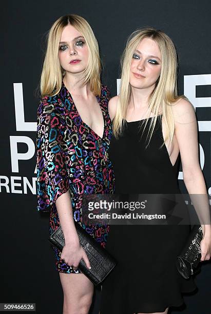 Actresses Elle Fanning and Dakota Fanning attend Saint Laurent at Hollywood Palladium on February 10, 2016 in Los Angeles, California.