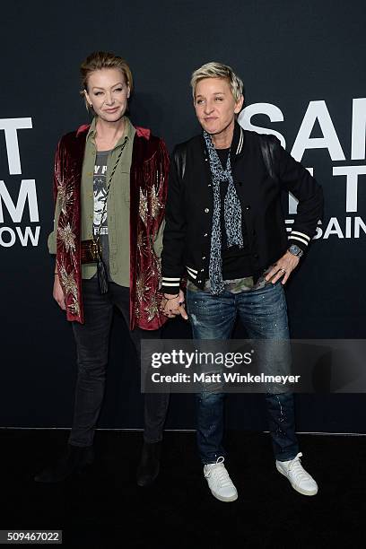 Actress Portia de Rossi, in Saint Laurent by Hedi Slimane, and TV Personality Ellen DeGeneres arrive at the Saint Laurent show at the Hollywood...