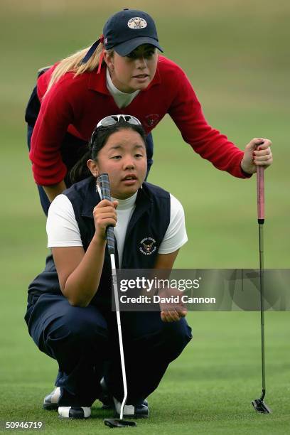 Jane Park of the USA and her partner Paula Creamer of the USA line up a putt on the 3rd green, during practice for the 2004 Curtis Cup Matches at...