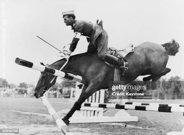 Danish competitor Major N Mikkelsen fails to win the Jumping Test event as his horse, St Hans, demolishes a fence, 13th August 1948. The Test was...