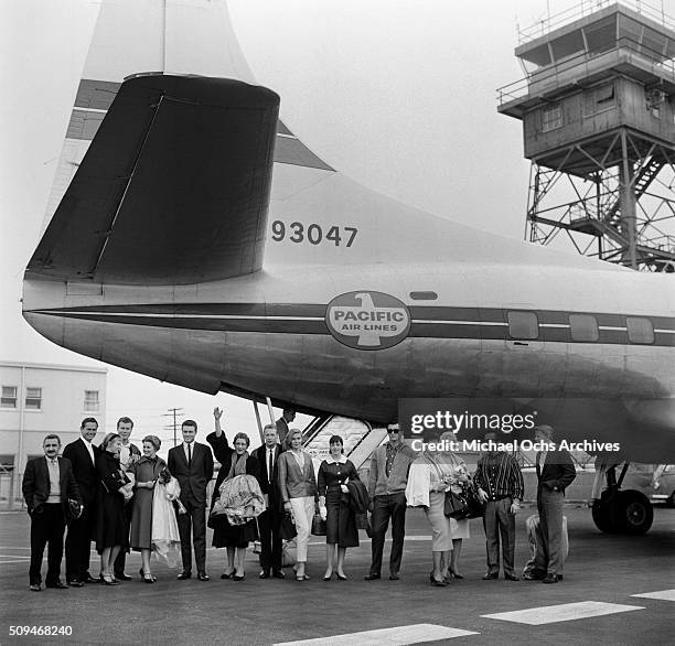 Young dancers from the Television Show " Lets Dance" wave as they board a plane in Los Angeles,California.