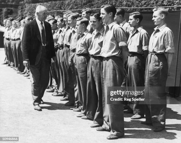 Ball boy trainer F. Fagg inspects a group of Wimbledon ball boys, all from Barnardo's children's homes, during their training at the William Baker...