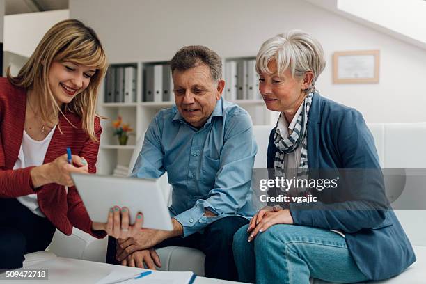 senior couple meeting with financial advisor - old accountant stock pictures, royalty-free photos & images