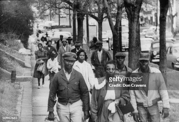 African Americans walk to work instead of riding the bus during the third month of an eventual 381-day bus boycott, Montgomery, Alabama, February...
