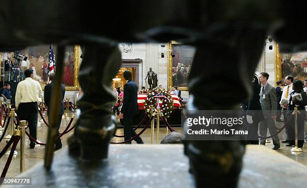 Visitors pay their respects at former President Ronald Reagan's casket inside the U.S. Capitol June 10, 2004 in Washington, DC. Reagan's body will...