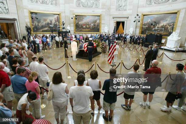 Visitors pay their respects at former President Ronald Reagan's casket inside the U.S. Capitol June 10, 2004 in Washington, DC. Reagan's body will...