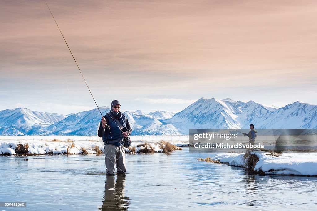 Two Fly Fisherman In The River During Winter