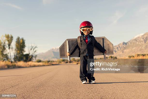 young boy wearing business suit and jet pack flies - resourceful bildbanksfoton och bilder