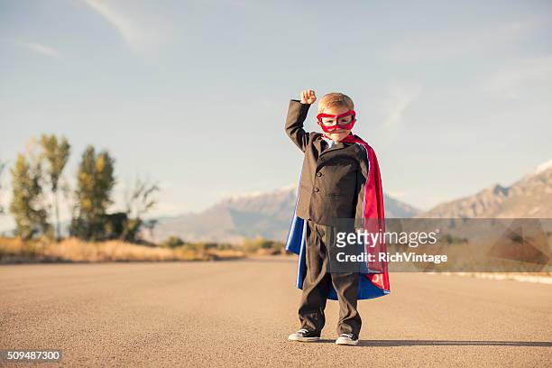 young boy wearing superhero costume and business suit - super excited suit stock pictures, royalty-free photos & images