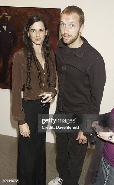 Coldplay singer Chris Martin and photogrpaher Taryn Simon attend an exhibit known as "The Innocents" at the Gogasian Gallery June 10, 2004 in London,...