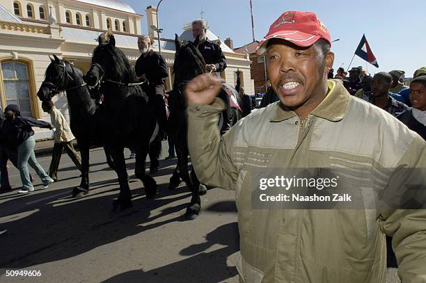 Black resident of Potchefstroom is seen as part of a crowd that gathered to see Eugene Terreblanche , former leader of the neo-nazi Afrikaner...