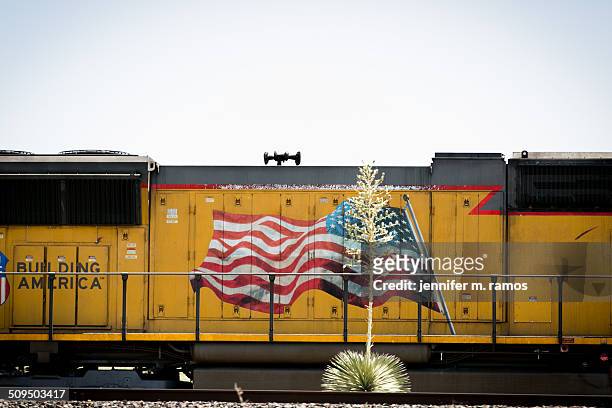 agave plant in front of a train with a flag waving - marfa texas stock pictures, royalty-free photos & images