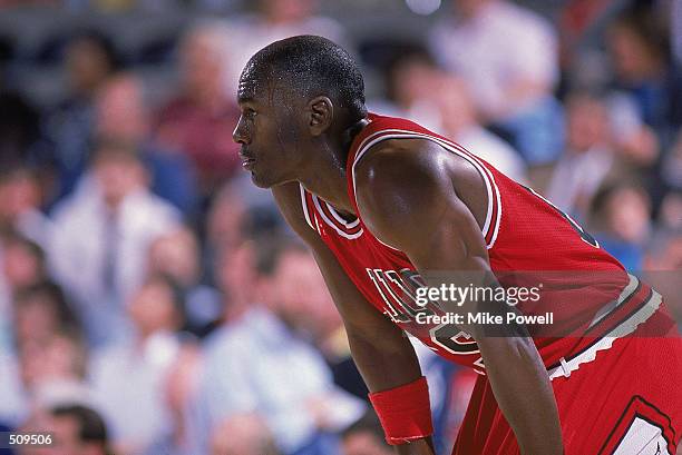 Michael Jordan of the Chicago Bulls rests on the court during a game. NOTE TO USER: User expressly acknowledges and agrees that, by downloading...