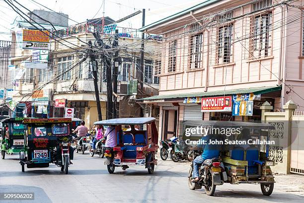 tricycle taxis - filipino tricycle stock pictures, royalty-free photos & images