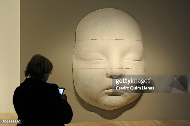 Visitor looks at the sculpture named 'Rostro de Carmen dormida' by Antonio Lopez during the press opening of the exhibition 'Realistas de Madrid' at...