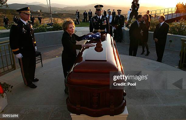 Former first lady Nancy Reagan leans into the casket of former President Ronald Reagan during the interment ceremony at the Ronald Reagan...