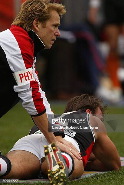 Aaron Hamill of the Saints is treated by medical staff for a possible leg injury during the round 12 AFL match between the Western Bulldogs and the...