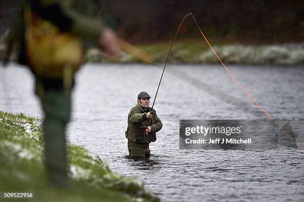 An angler fishes on the opening day of the salmon season on the River Spey on February 11, 2016 in Aberlour, Scotland. The annual opening day...