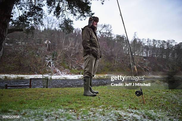 An angler stands during the opening day of the salmon season on the River Spey on February 11, 2016 in Aberlour, Scotland. The annual opening day...