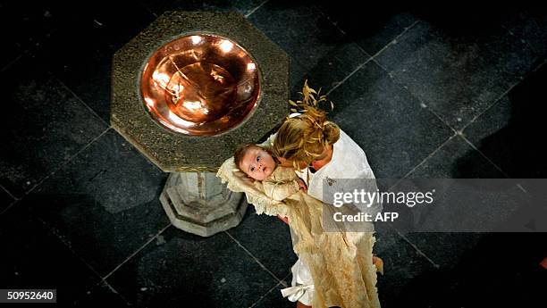 Dutch Princes Maxima stands with her daughter Catharina-Amalia in the St-Jacobs church for her christening in The Hague 12 June 2004. AFP PHOTO...