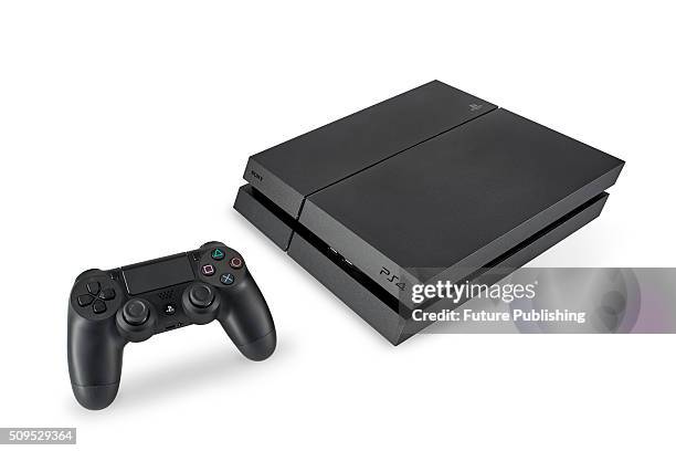 Sony PlayStation 4 home video game console and DualShock 4 wireless controller, taken on January 22, 2016.