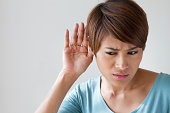 woman suffers from auditory impairment, hard of hearing