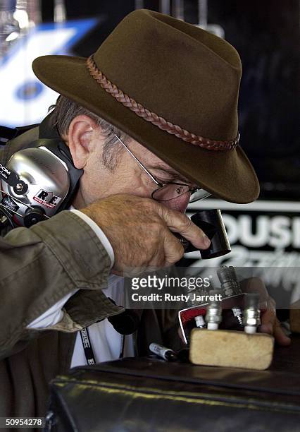 June 12: Jack Roush, owner of Roush Racing, reads spark plugs during practice for the Nextel Cup Pocono 500, on June 12, 2004 at Pocono Raceway in...