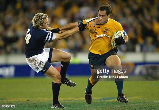 George Smith of the Wallabies is tackled by Sean Lamont of Scotland during the Hopetoun Cup test match between the Australian Wallabies and Scotland...