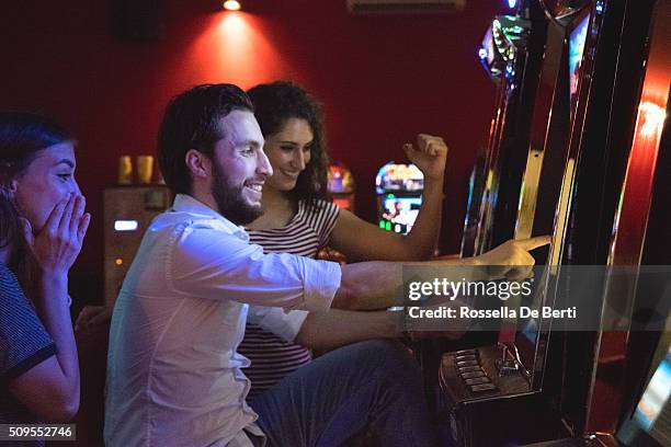 friends playing the slots - free bet slots no deposit【th733com】triple lucky slot machine stock pictures, royalty-free photos & images