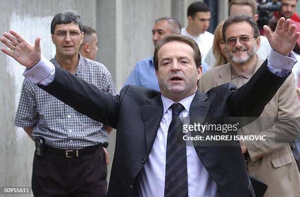 Bogoljub Karic, an independent presidental candidate, waves to the media in front of a polling station in Belgrade, 13 June 2004. The election...