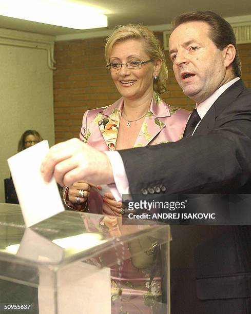 Bogoljub Karic, independent presidental candidate, and his wife Milanka cast their votes at a polling station in Belgrade 13 June 2004. The election...