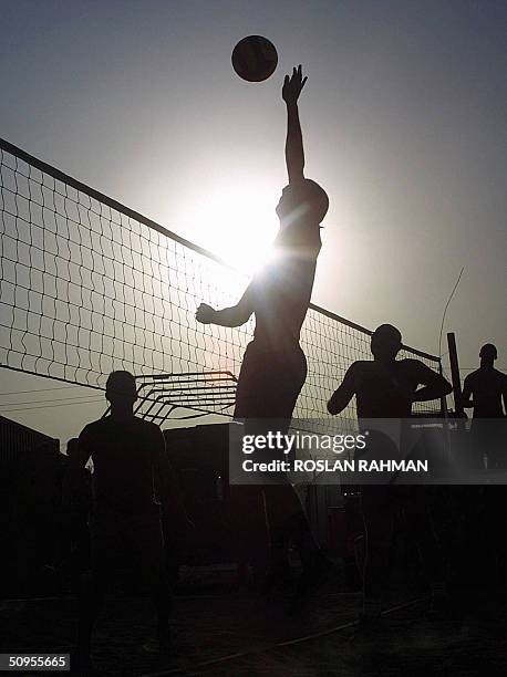 The US and Thai coalition soldiers play beach volley ball in Camp Lima at the outskirt, east of the city of Karbala , some 100kms south of Baghdad 12...