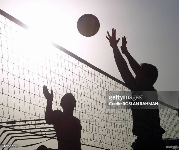The US and Thai coalition soldiers play beach volley ball in Camp Lima at the outskirt, east of the city of Karbala , some 100kms south of Baghdad 12...