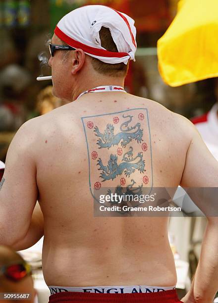 An England fan with a 'Three Lions' tattoo on his back in Rossi Square in Lisbon waiting for the start of Englands first game at the Euro 2004...