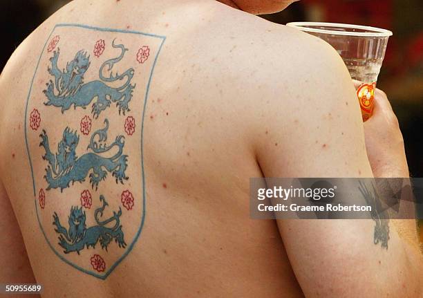 An England fan with a 'Three Lions' tattoo on his back in Rossi Square in Lisbon waiting for the start of Englands first game at the Euro 2004...