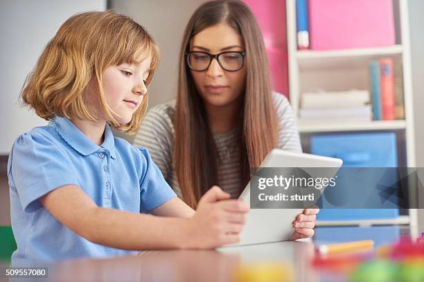 digital tablet in classroom - teaching assistant stock pictures, royalty-free photos & images