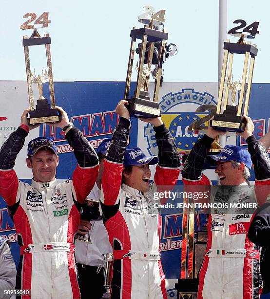 Danish Tom Kristensen , Japan Seiji Ara and Italian Rinaldo Capello , drivers of Audi number 5, jubilate after winning 24-hour race which finished at...
