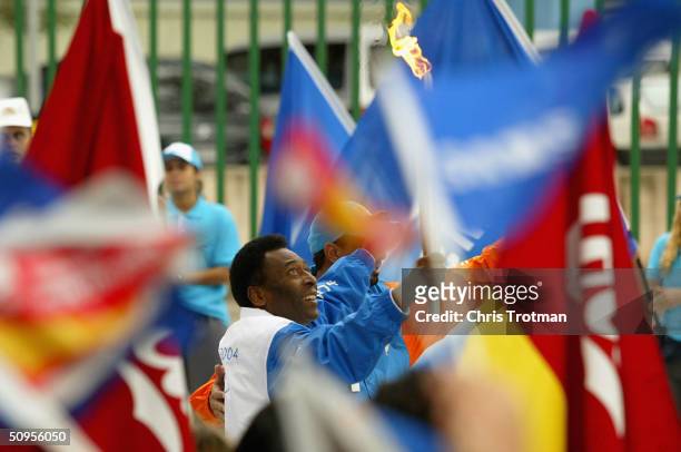 Brazilian soccer legend and first torchbearer Pele carries the Olympic Flame from Maracana Stadium at the start of day 10 of the ATHENS 2004 Olympic...