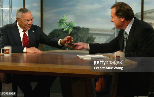 Secretary of State Colin Powell accepts the first annual Colin Powell Palm Tree Award from moderator Tim Russert June 13, 2004 during a taping of...
