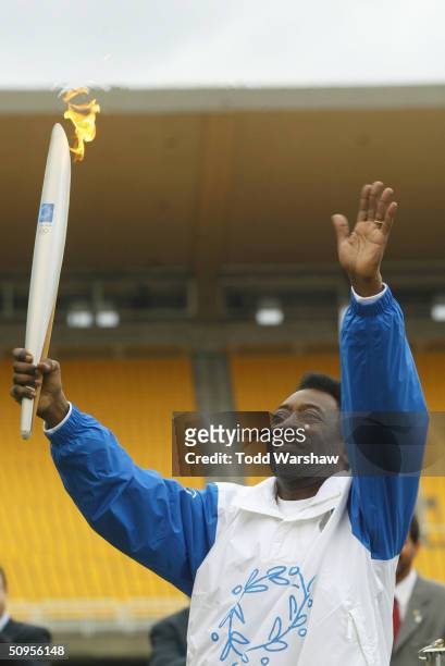 Soccer star Pele carries the Olympic Flame inside Maracena Stadium during Day 10 of the ATHENS 2004 Olympic Torch Relay June 13, 2004 in Rio De...