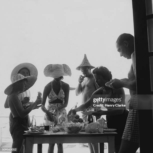 Baroness Alain de Rothschild, Georges Niles, Mrs. Walter Hirshon, and Robert Minton, picnicking in Biarritz.