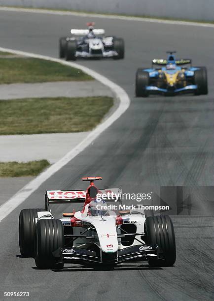 Jenson Button of Great Britain and B.A.R leads Fernando Alonso and Juan Pablo Montoya during the Canadian F1 Grand Prix on June 13 at the Circuit...