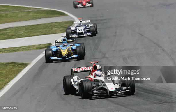 Jenson Button of Great Britain and B.A.R leads Fernando Alonso and Juan Pablo Montoya during the Canadian F1 Grand Prix on June 13 at the Circuit...