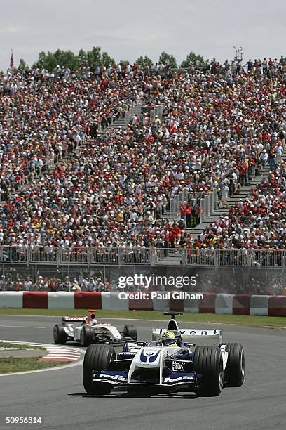 Ralf Schumacher of Germany and BMW Williams leads Jenson Button of Great Britain and B.A.R during the Canadian F1 Grand Prix at the Circuit Gilles...